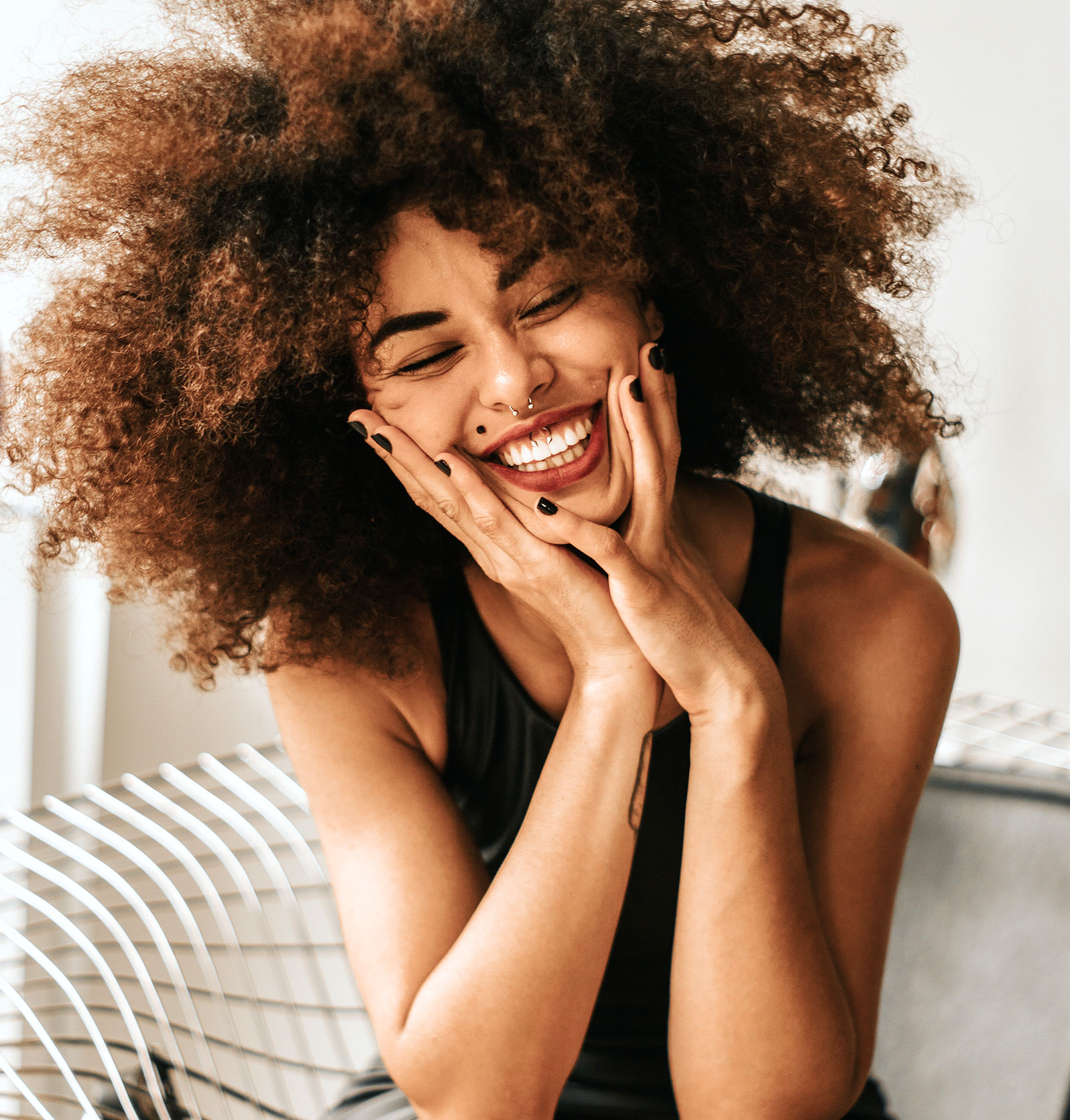 Woman smiling african american young women sitting smiling