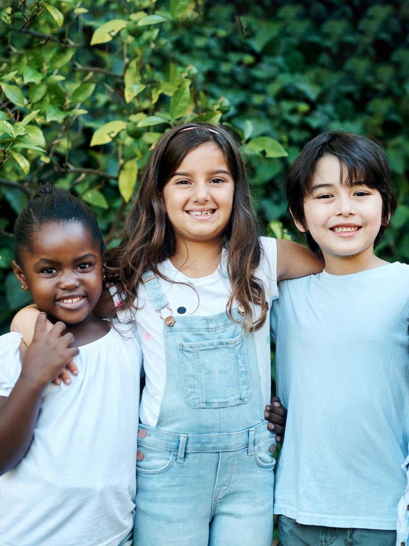 group-kids Group of diverse kids standing next to each other and linking arms